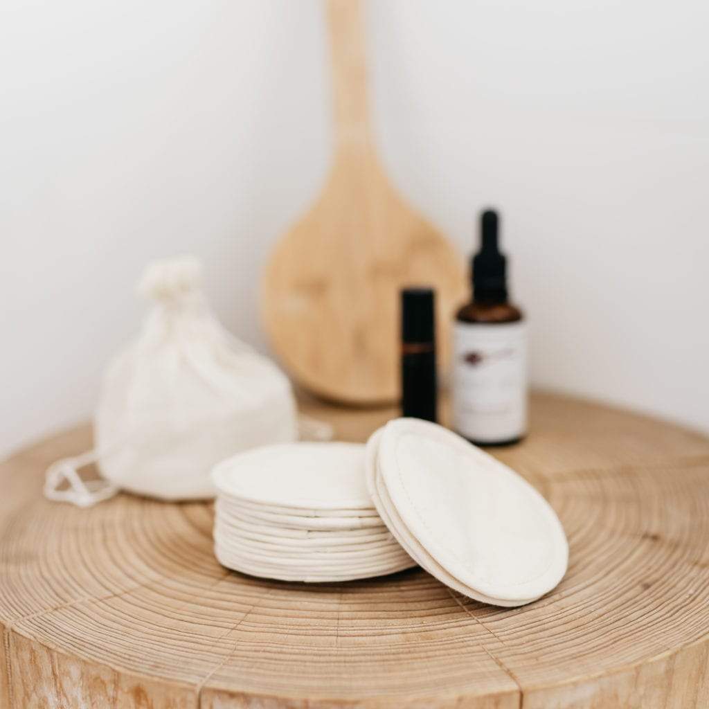 The Swag Beauty Swag Set sitting on a wooden table with a stack of the reusable beauty rounds sitting on the table - The Swag AU